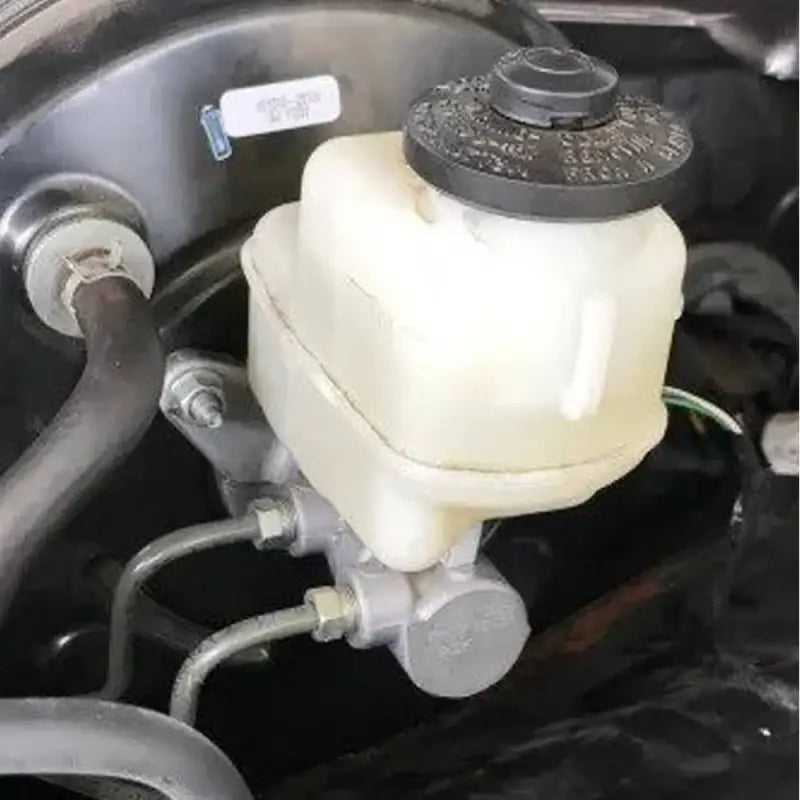 Installed Toyota Tacoma master cylinder showing secure fitment and connection to brake lines for rear disc conversion.