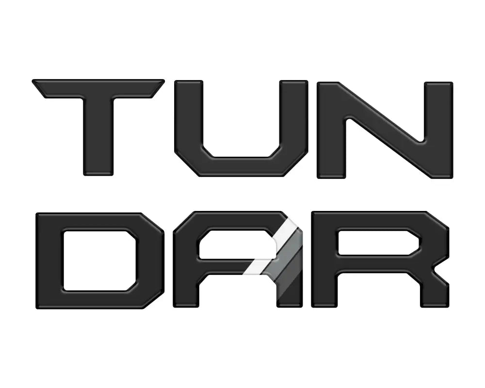 Black tailgate letter inserts with gray and white stripe accents for Toyota Tundra 2014-2021, offering a sleek look.