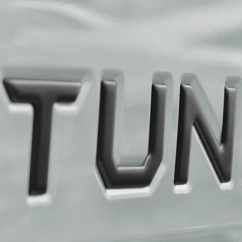 Close-up of black tailgate letter inserts for 2014-2021 Toyota Tundra, showcasing a sleek and durable design.