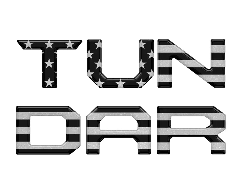 Black and gray American flag tailgate letter inserts for Toyota Tundra 2014-2021, featuring a subdued aesthetic.
