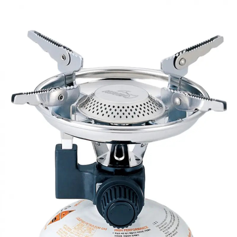 Kovea Scout Stove attached to a gas canister, featuring foldable arms and a durable design for camping and outdoor use.