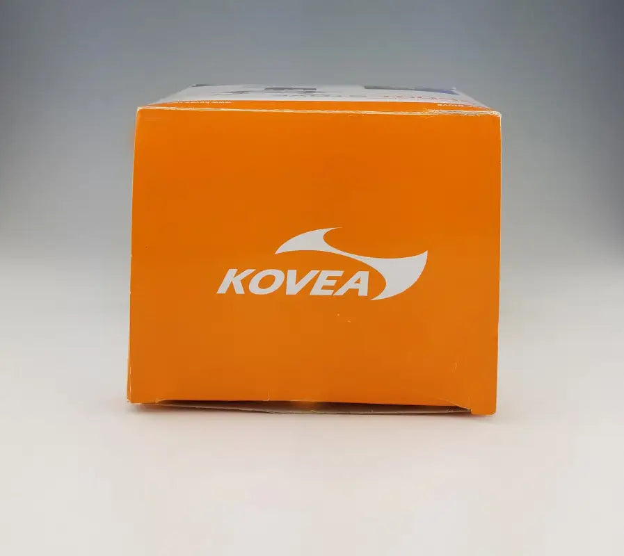 Side view of Kovea Scout Stove packaging with orange branding, showcasing its compact and portable design for camping.