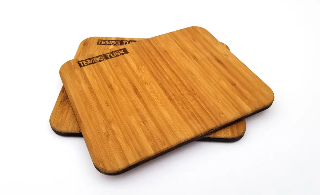 Stacked TemboTusk bamboo cutting boards, pre-oiled and compact, ideal for camping or overland cooking setups, made in the USA.