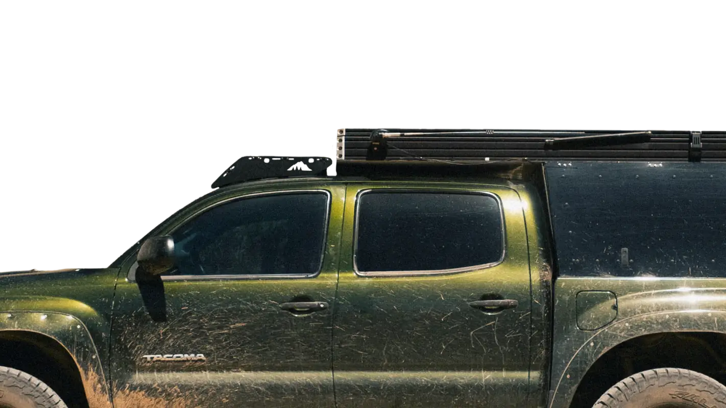 Close-up of Animas roof rack mounted on a green Toyota Tacoma camper, highlighting its sturdy design and compatibility.