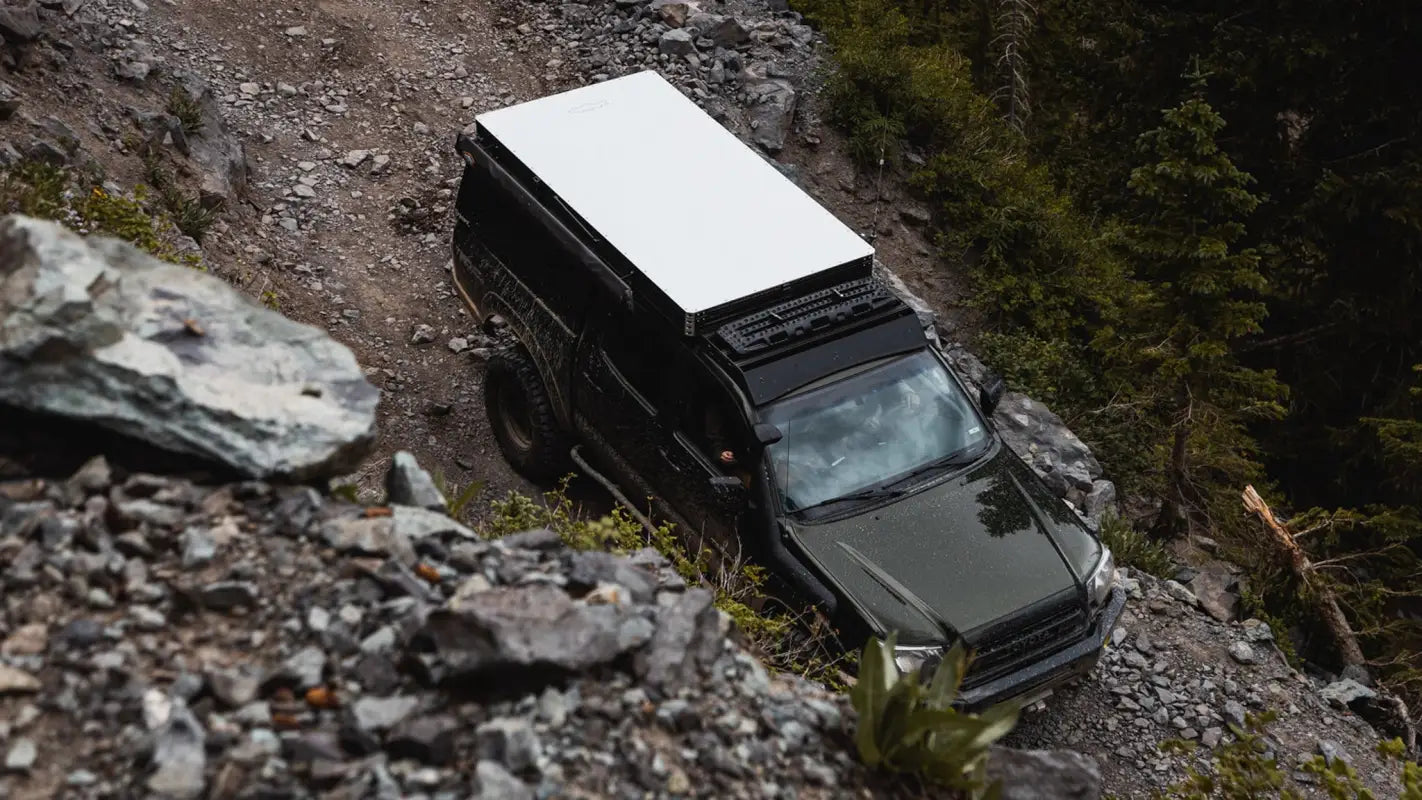 Overhead view of Toyota Tacoma with Animas roof rack and camper, emphasizing its utility for outdoor exploration.