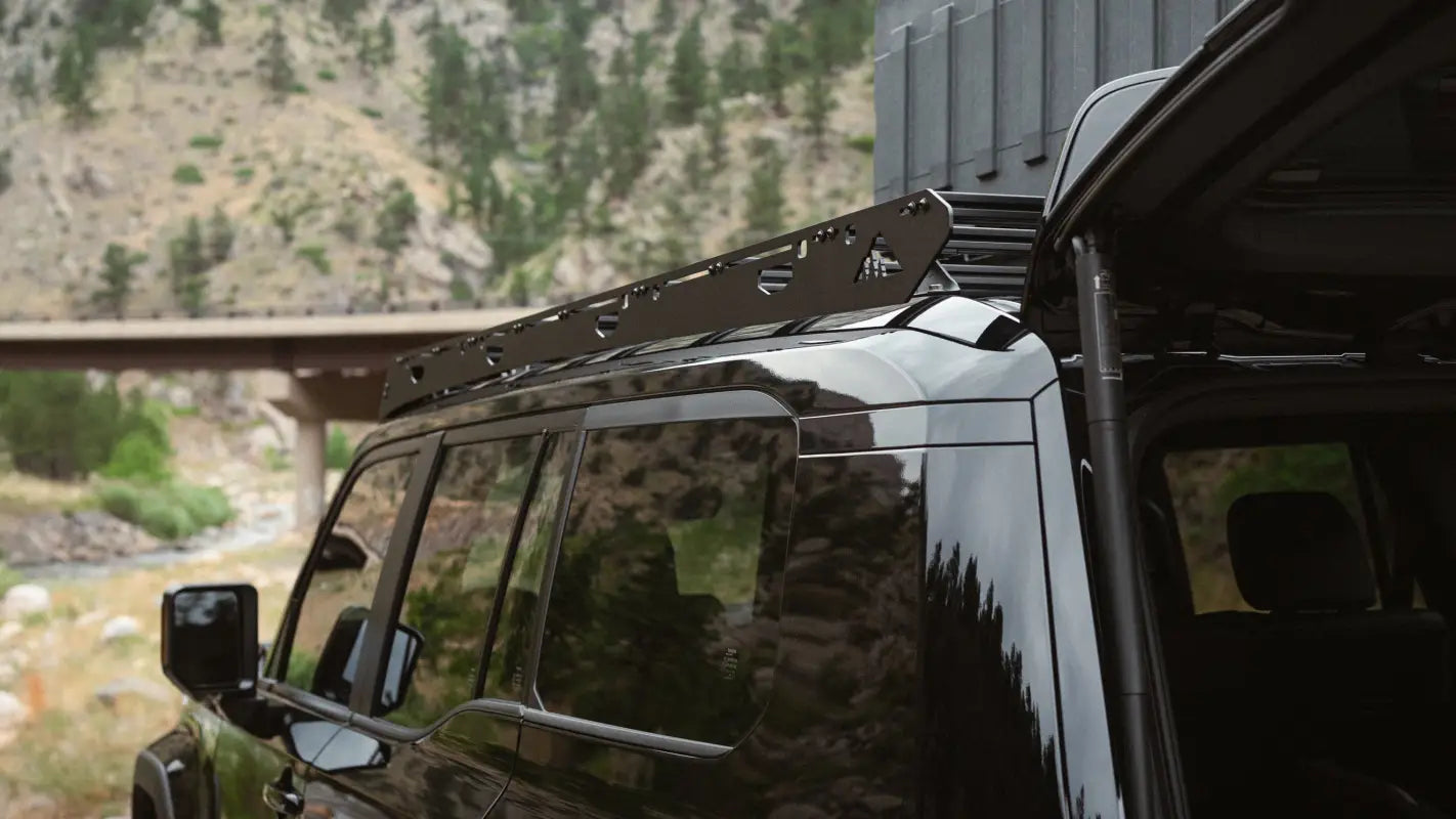 Detailed side view of The Atlas roof rack on a black 2024 Toyota Land Cruiser, emphasizing its precision-engineered fit.