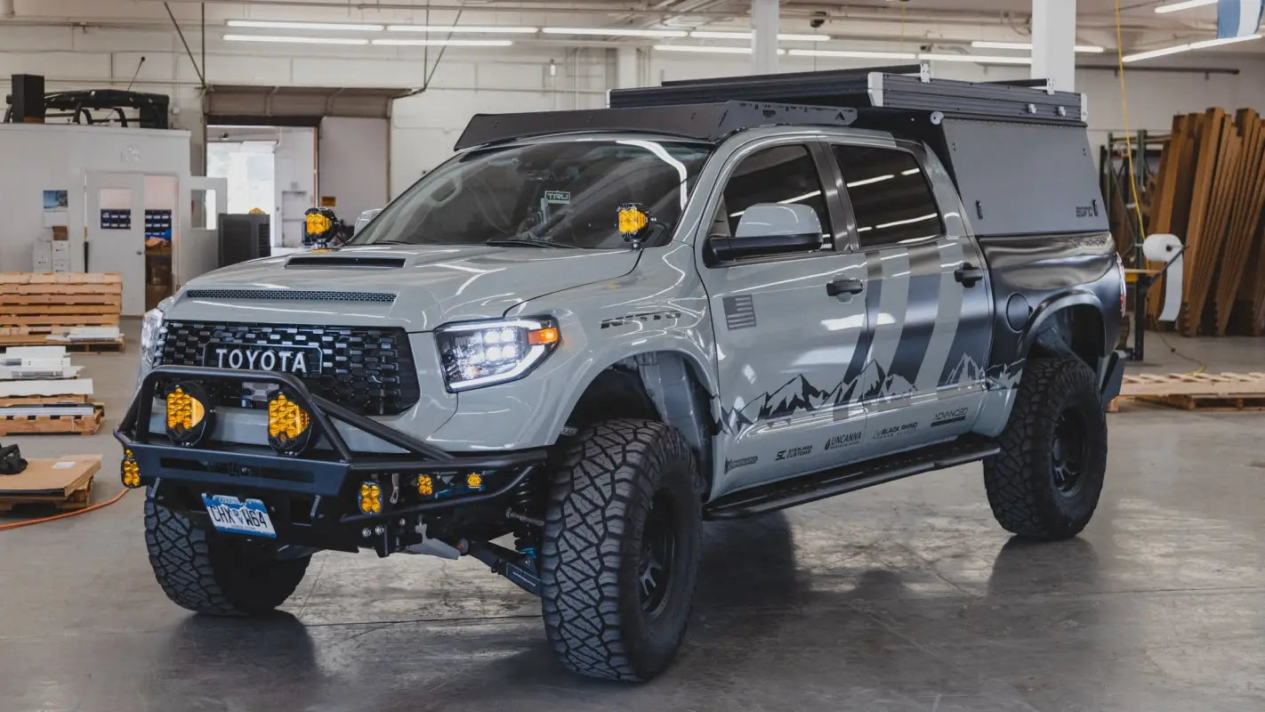 Toyota Tundra equipped with Bear Paw Roof Rack and camper, designed for off-road adventures and enhanced cargo capacity.