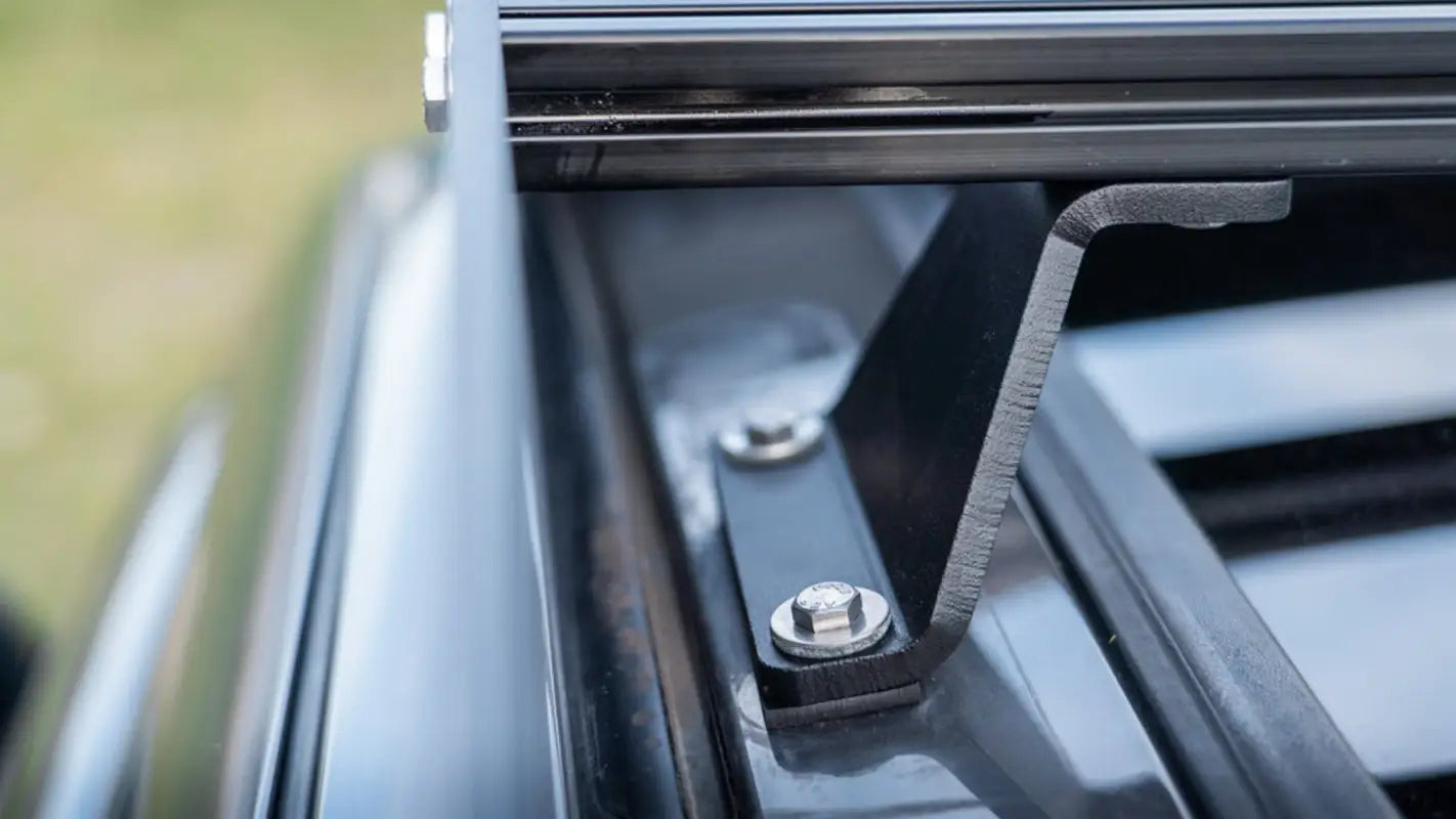 Detailed close-up of the mounting brackets for the Belford roof rack, showing secure bolting and drill-free installation on a Toyota Sequoia.