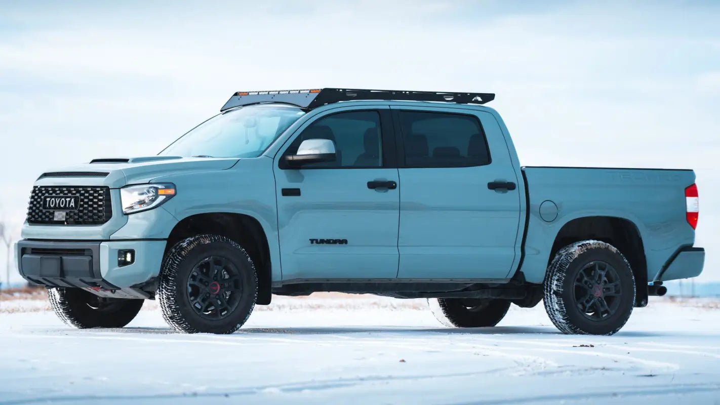 Toyota Tundra CrewMax in light blue with Big Bear Roof Rack, highlighting sleek aluminum design for secure cargo transport.