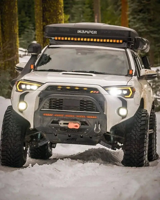 Toyota 4Runner equipped with Brite Box and additional lighting accessories, driving through snowy terrain with enhanced visibility.