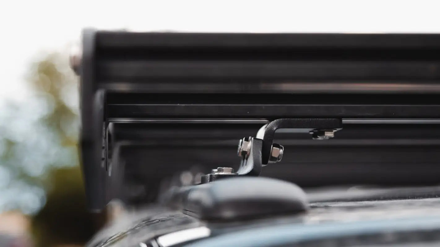 Detailed view of the Crow’s Nest rack mounting system, demonstrating its robust and secure attachment to the truck roof.