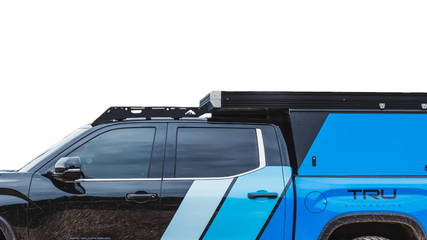 Close-up of The Cub Roof Rack on a Toyota Tundra, showcasing rivet attachments and sleek design for secure camper storage.