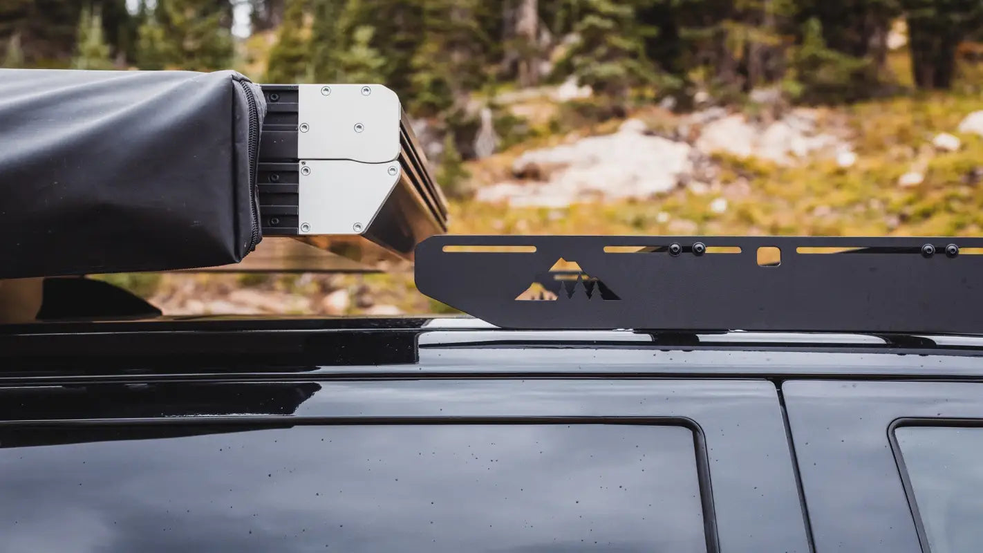 Detailed view of The Cub Roof Rack's rivet attachments and crossbars on a Toyota Tundra, highlighting its durable construction.