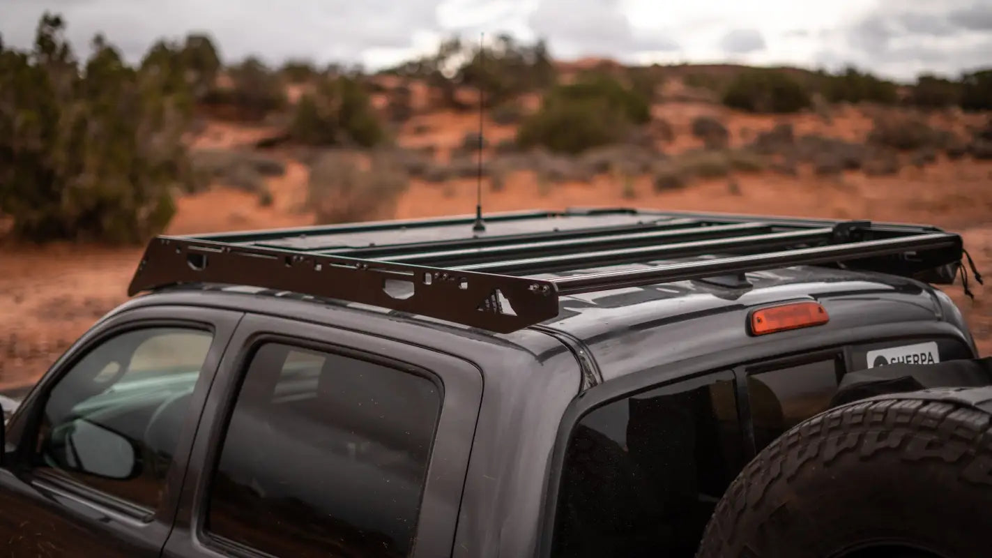 Rear angled view of the Grand Teton roof rack on a Toyota Tacoma, emphasizing its drill-free installation and sturdy build.