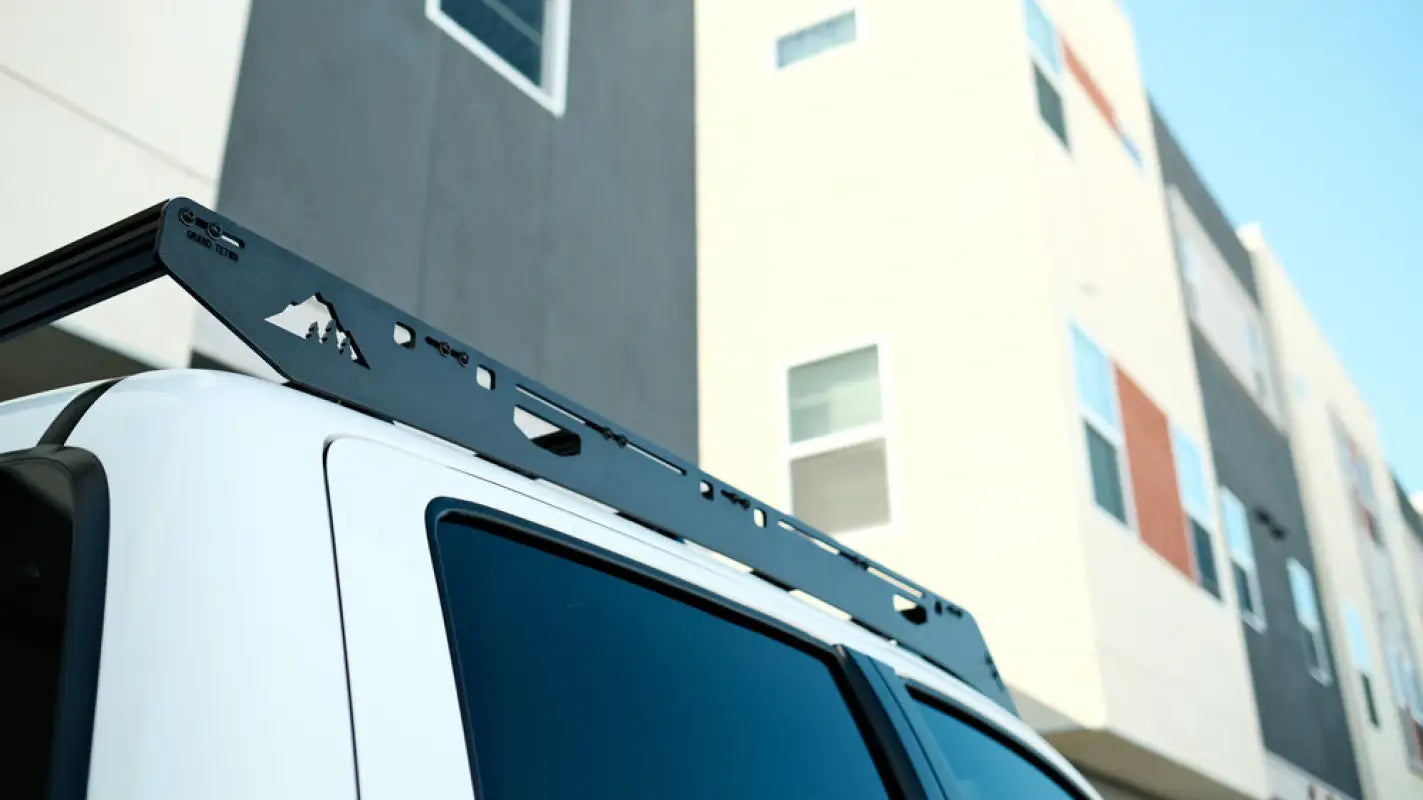 Close-up of the Grand Teton roof rack on a white Toyota Tacoma, showcasing its precision-cut aluminum design and modern aesthetic.