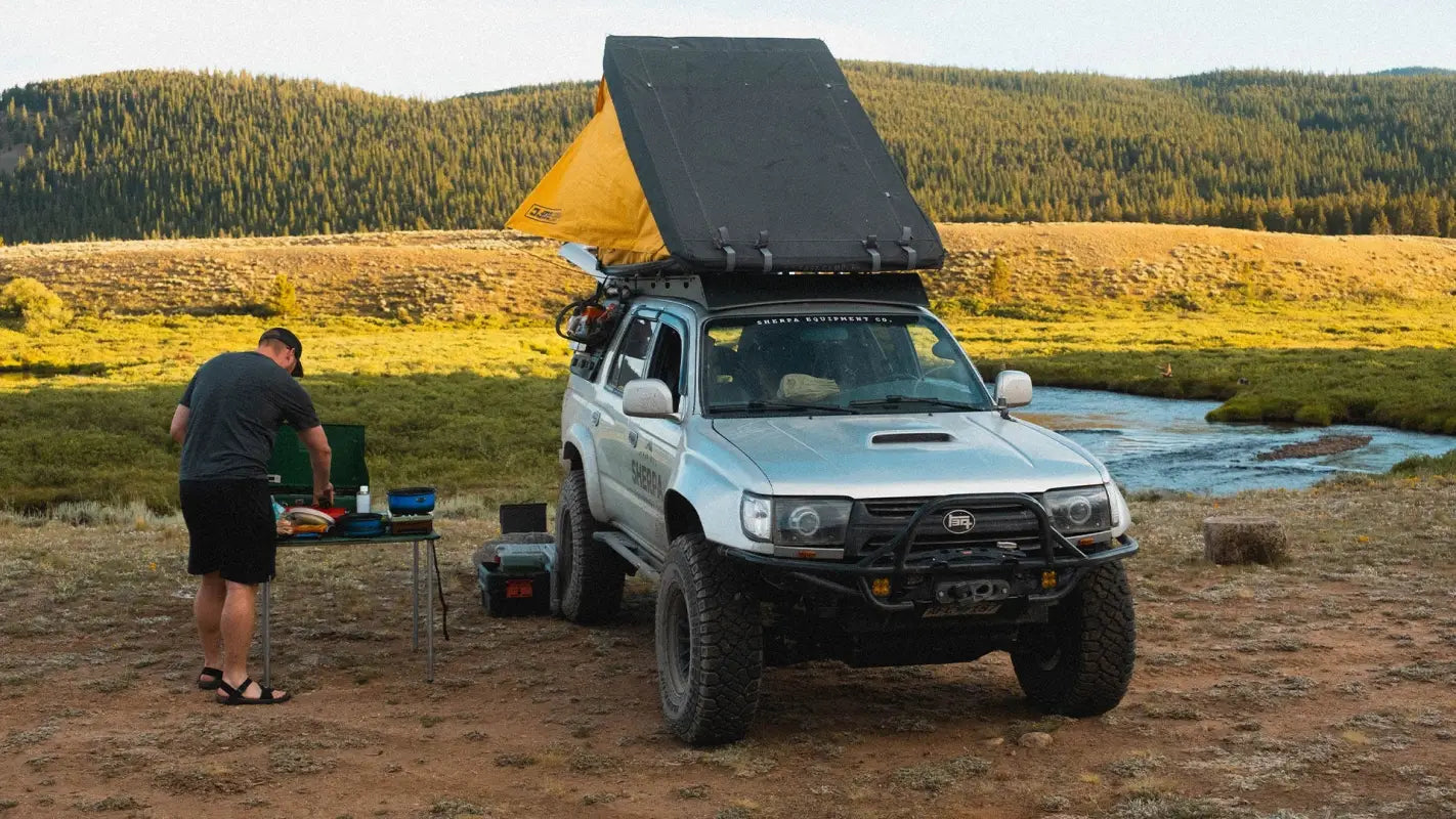 Toyota 4Runner with Matterhorn roof rack and rooftop tent setup, parked in a scenic outdoor camping area.