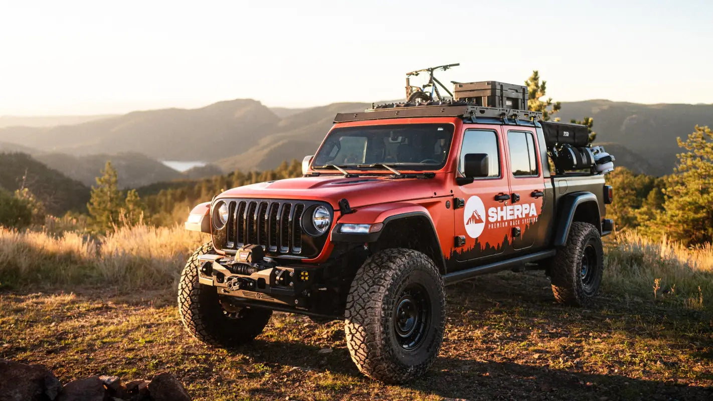 Jeep Gladiator JT fitted with The Sunlight roof rack in a scenic outdoor setting, carrying gear securely on its modular aluminum frame.