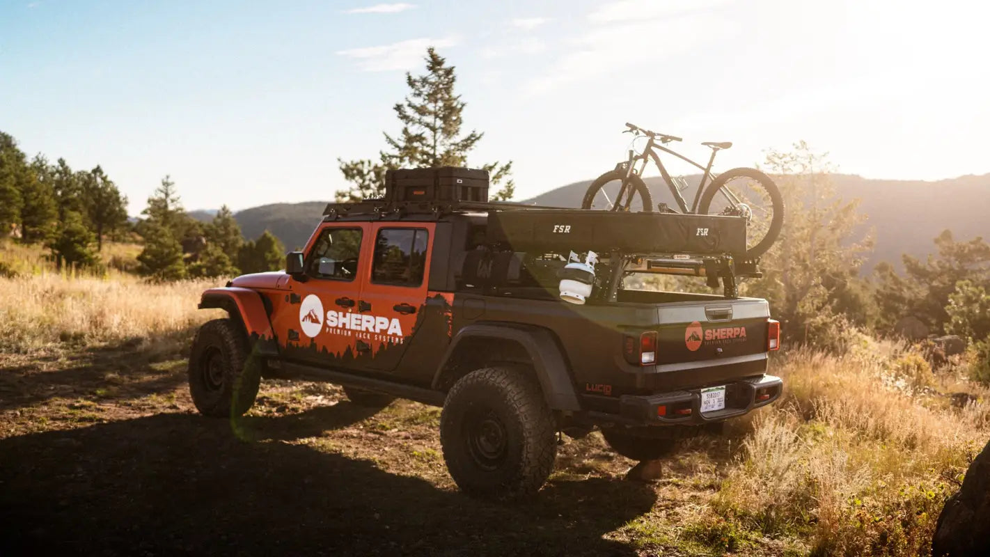 Rear view of Jeep Gladiator JT with The Sunlight roof rack, loaded with a bike and gear, highlighting its versatile cargo capacity.