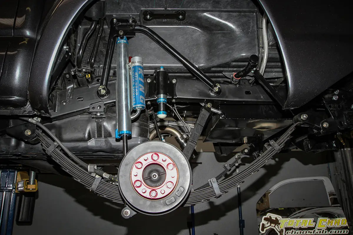TOTAL CHAOS bump stop kit with King 2.0 bump stops installed on a Toyota Tacoma rear suspension for enhanced off-road handling.