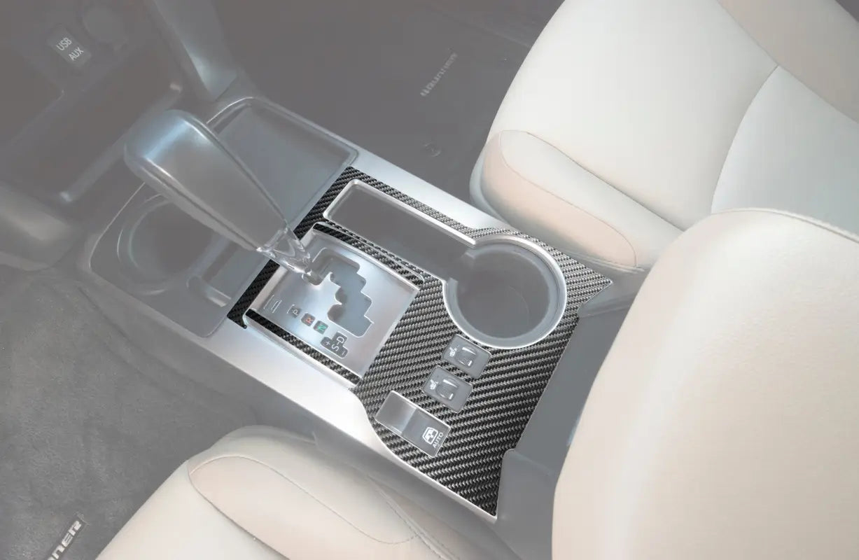 Carbon fiber-style transmission console accent trim installed in a 2014-2024 Toyota 4Runner interior, enhancing the vehicle's decor.