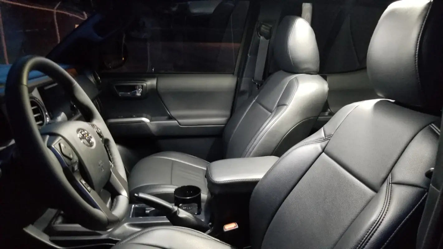 Interior of a 16-23 Tacoma with white LED Ultimate Map Lights providing clear illumination for the driver and passenger.