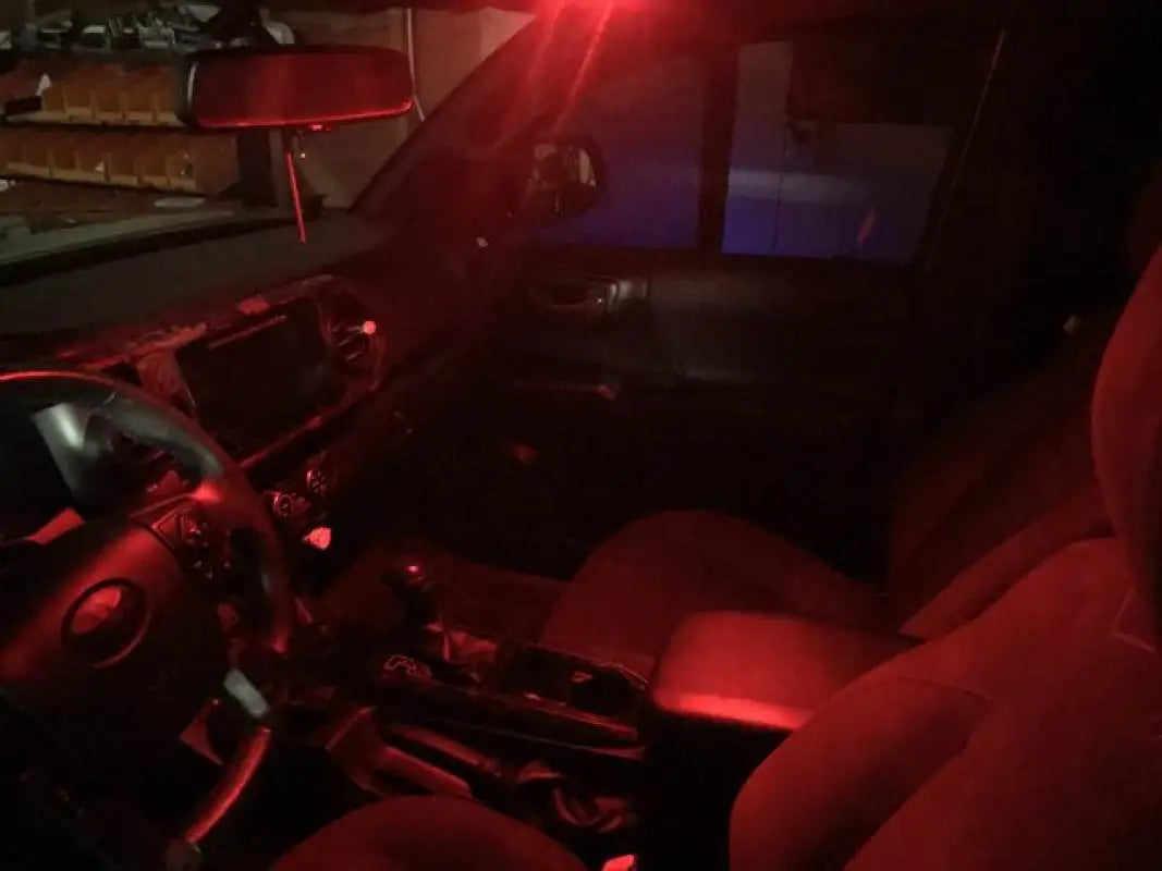 Red LED Ultimate Map Lights installed in a 16-23 Tacoma, creating a soft ambient glow in the vehicle's interior.