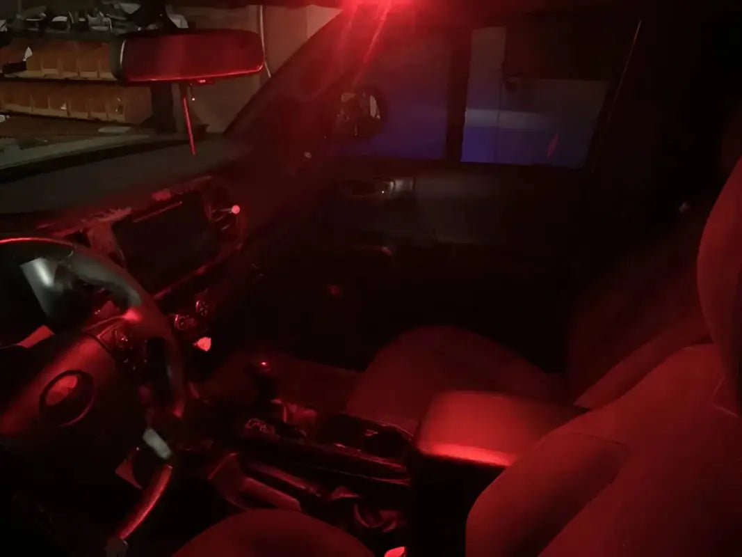 Red LED Ultimate Map Lights installed in a 16-23 Tacoma, creating a soft ambient glow in the vehicle's interior.