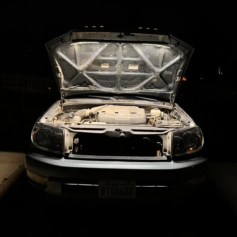 Toyota SUV with its engine bay illuminated by the under hood LED light kit, providing bright and even lighting at night.