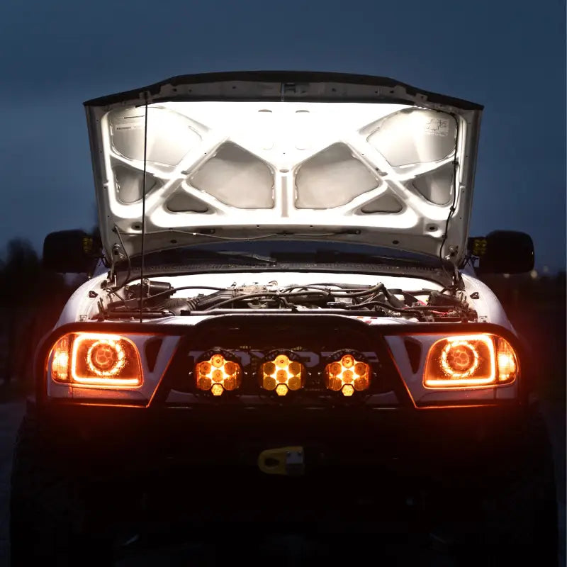 Under hood LED light illuminating the engine bay of a Toyota truck at night, showcasing bright 1,300-lumen output for maintenance visibility.