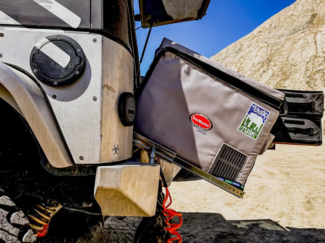 Close-up of a fridge mounted on the Universal Tilt Slide Adapter, demonstrating its secure and angled positioning for outdoor use.