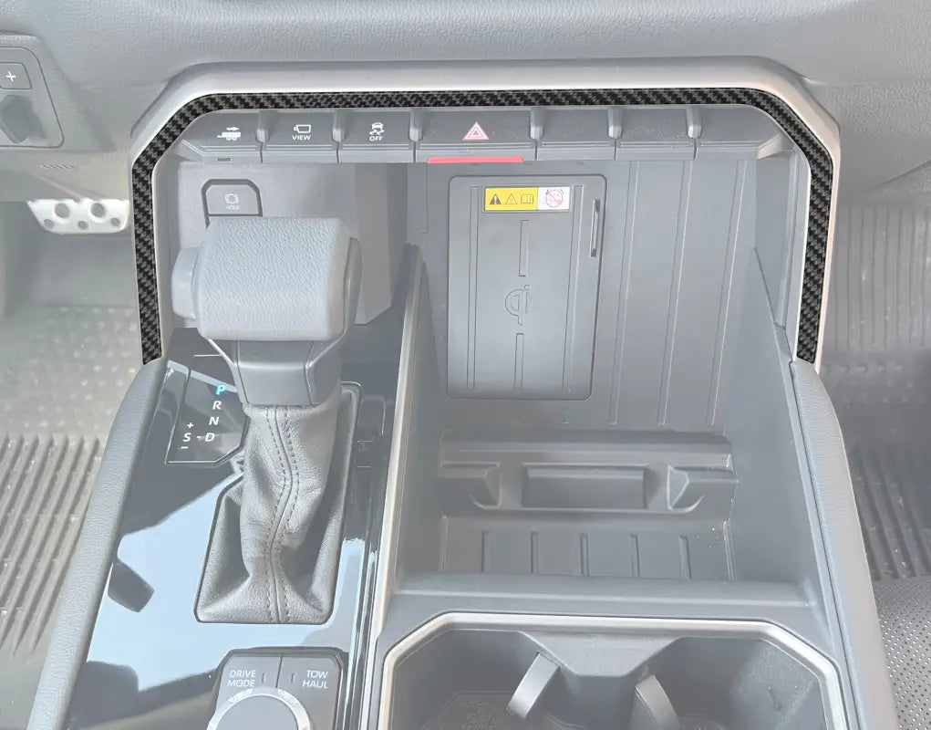 Upper center console line accent trim installed on a 2022-2024 Toyota Tundra or 2023-2024 Toyota Sequoia, showcasing a sleek carbon fiber design.