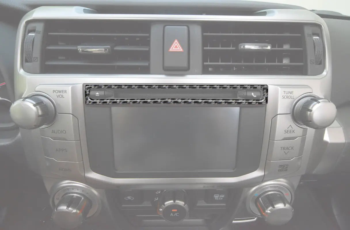 Upper radio display accent trim installed on a 2014-2024 Toyota 4Runner dashboard, showcasing a sleek carbon fiber design.