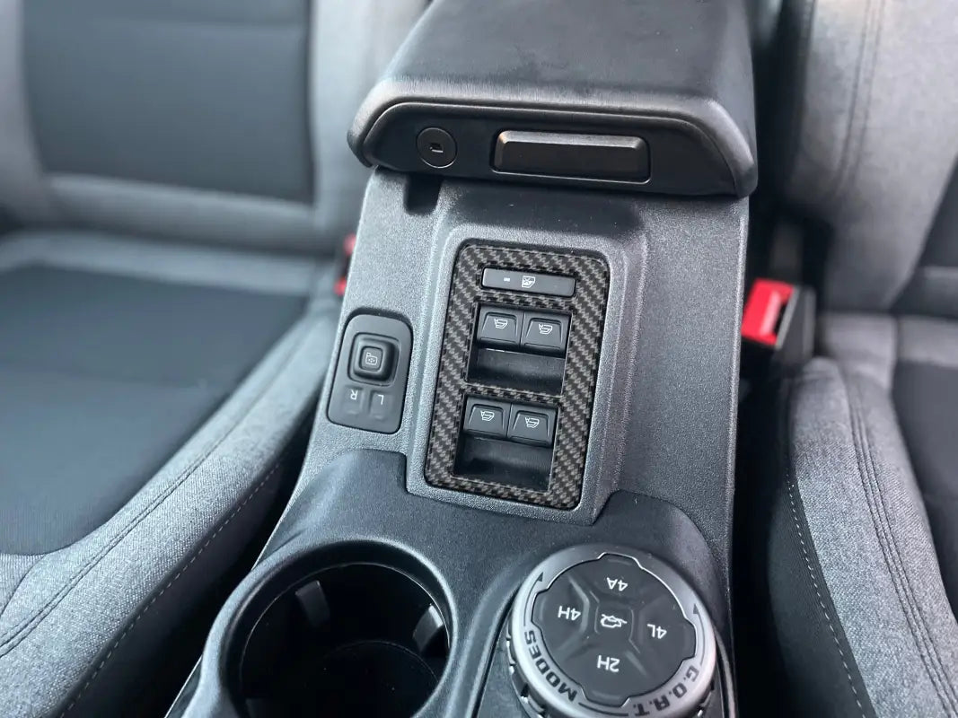 Window control switch with control switch accent overlay in Ford Bronco center console