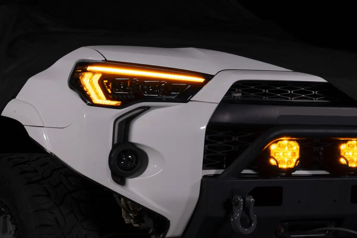 White Toyota 4Runner with XB Evo Headlights featuring aftermarket high beam and turn signals