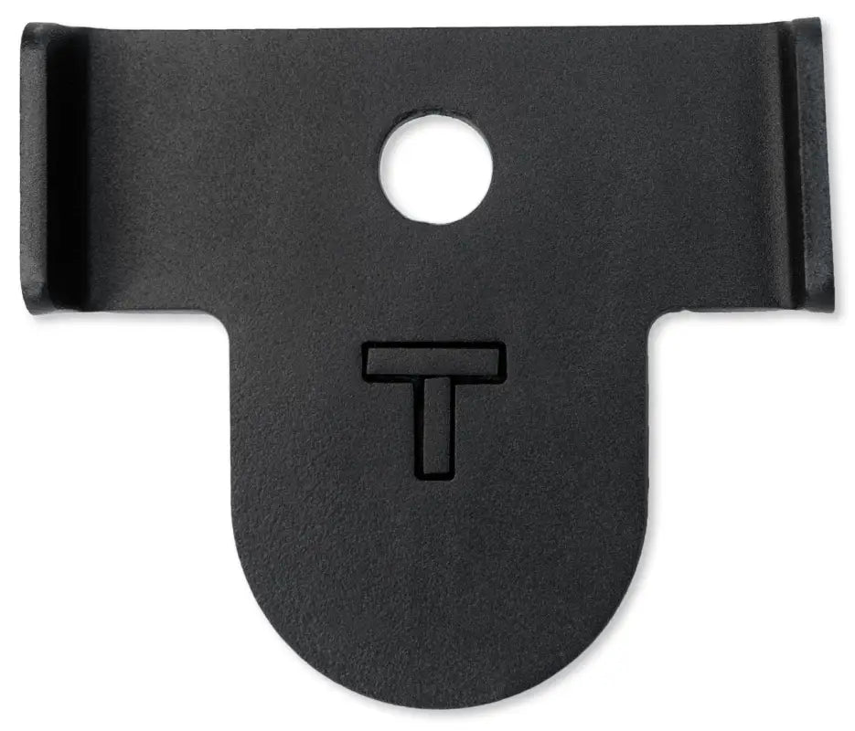 Black steel strike plate with a center hole and 'T' engraving, part of the Tacoma bolt-on bump stop kit for 2005-2021 models.