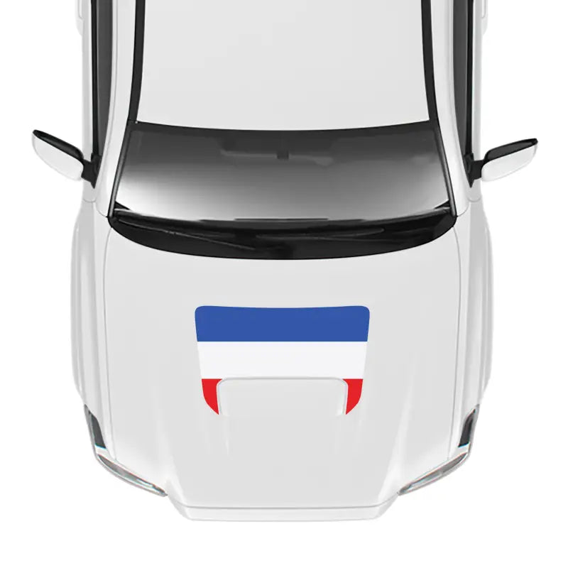 White car with flag decal showcasing 2016-23 Tacoma Pro Sport Hood Stamp and Sport Hood Decal
