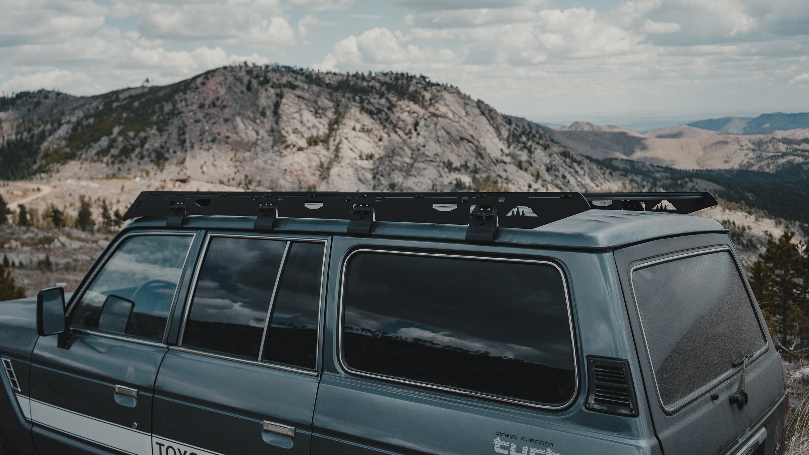 Angled view of the Toyota Land Cruiser roof rack highlighting its robust design, perfect for securing equipment during outdoor expeditions.