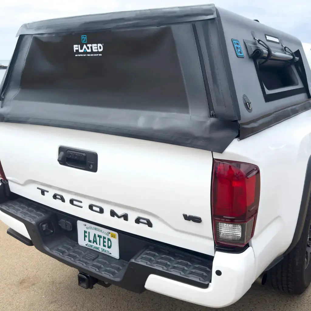 Rear view of a white truck with an inflatable truck cap securely installed, featuring a durable and weather-resistant design.