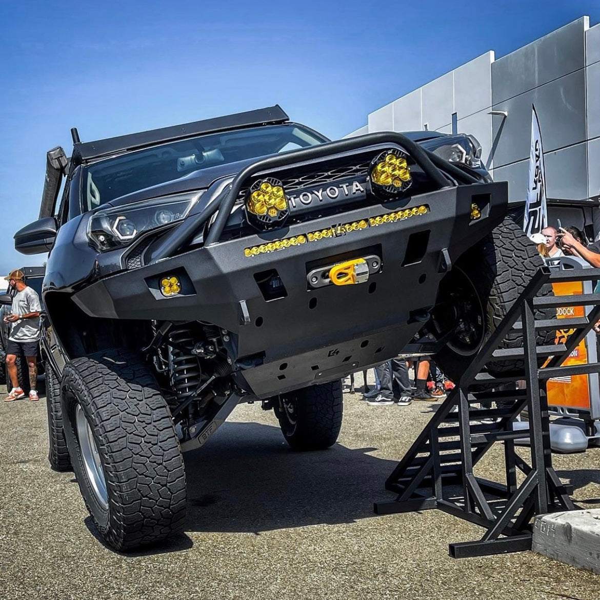 Modified 5th Gen 4runner with GX460 long travel suspension displayed on a ramp, emphasizing articulation and suspension travel.