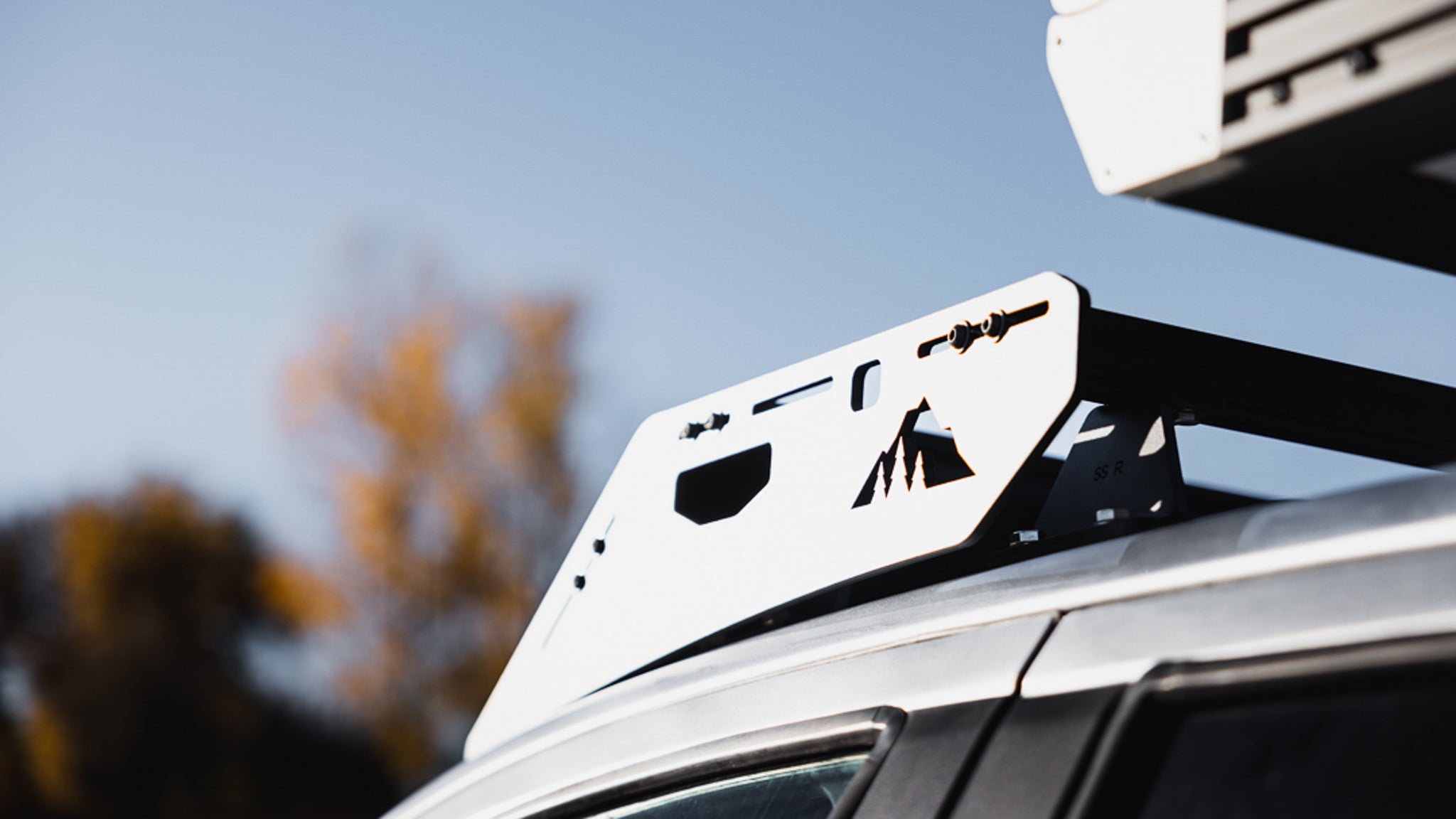 Detailed view of Stratus roof rack side panel with mountain cutout design, emphasizing style and functionality for outdoor gear.