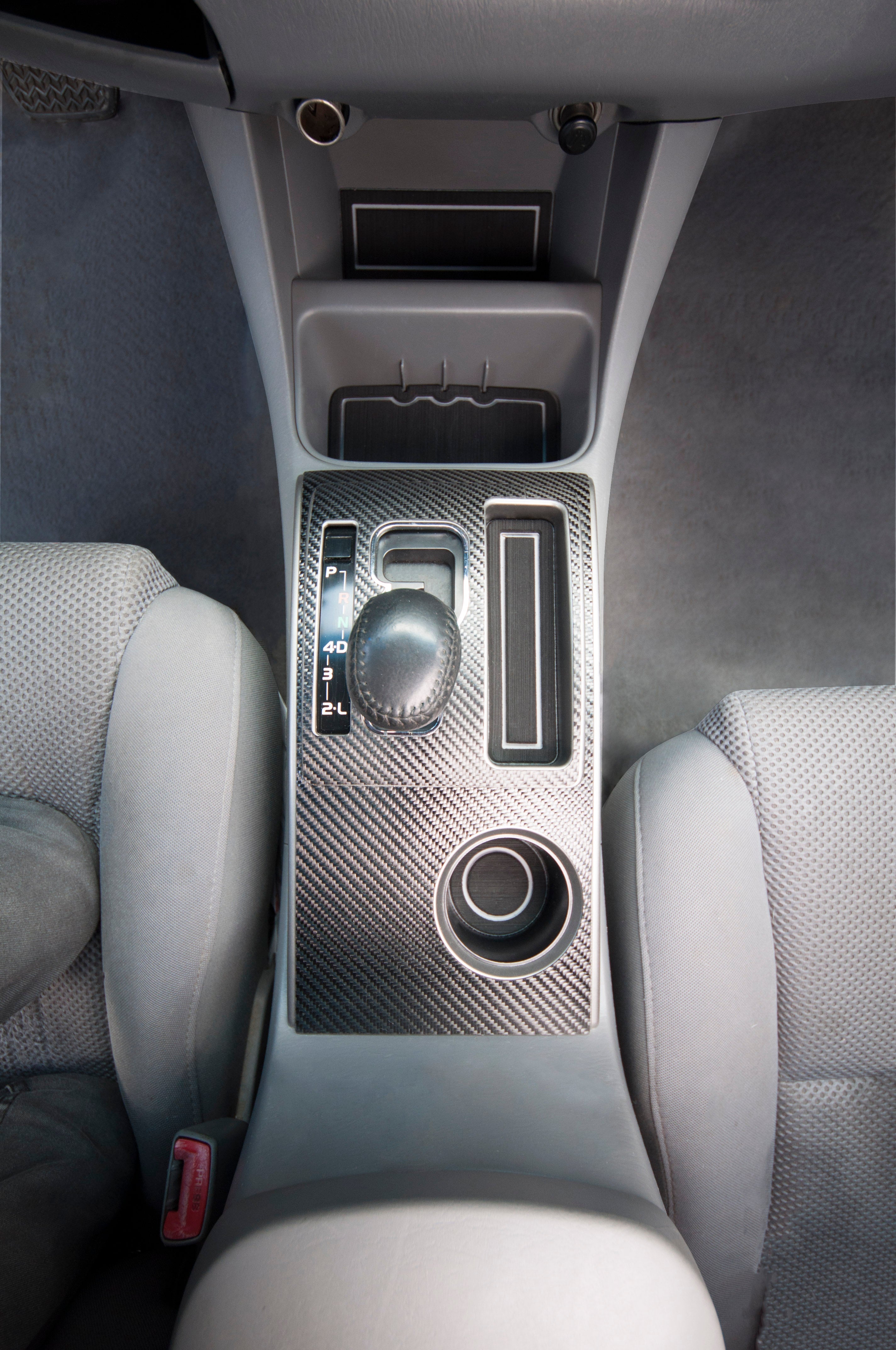 Close-up view of foam cup holder inserts fitted in the center console of a Toyota Tacoma, enhancing interior aesthetics and functionality.