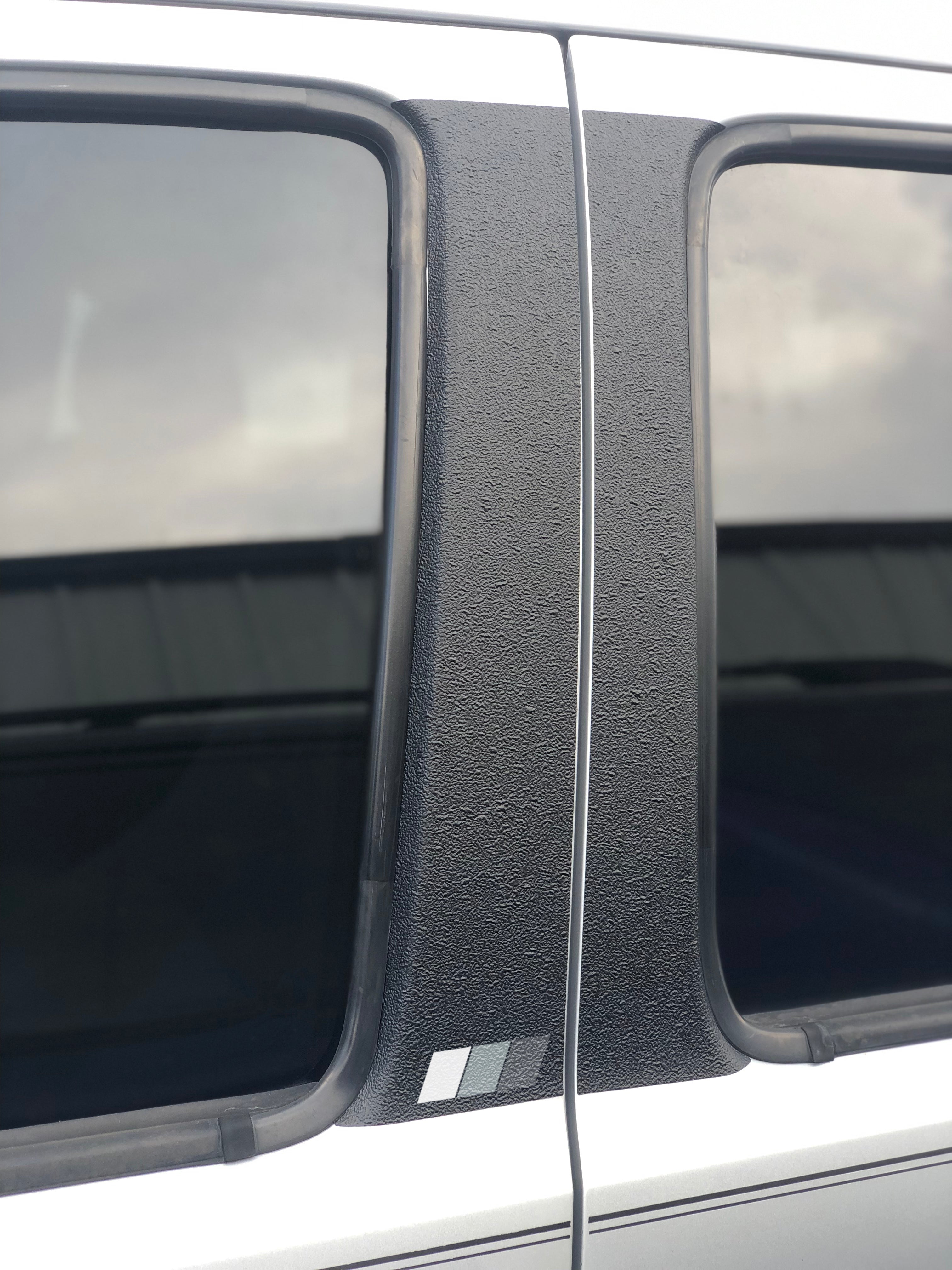 Textured door pillar protection overlay with tri-color accents in gray tones, fits 2005-2015 Toyota Tacoma.