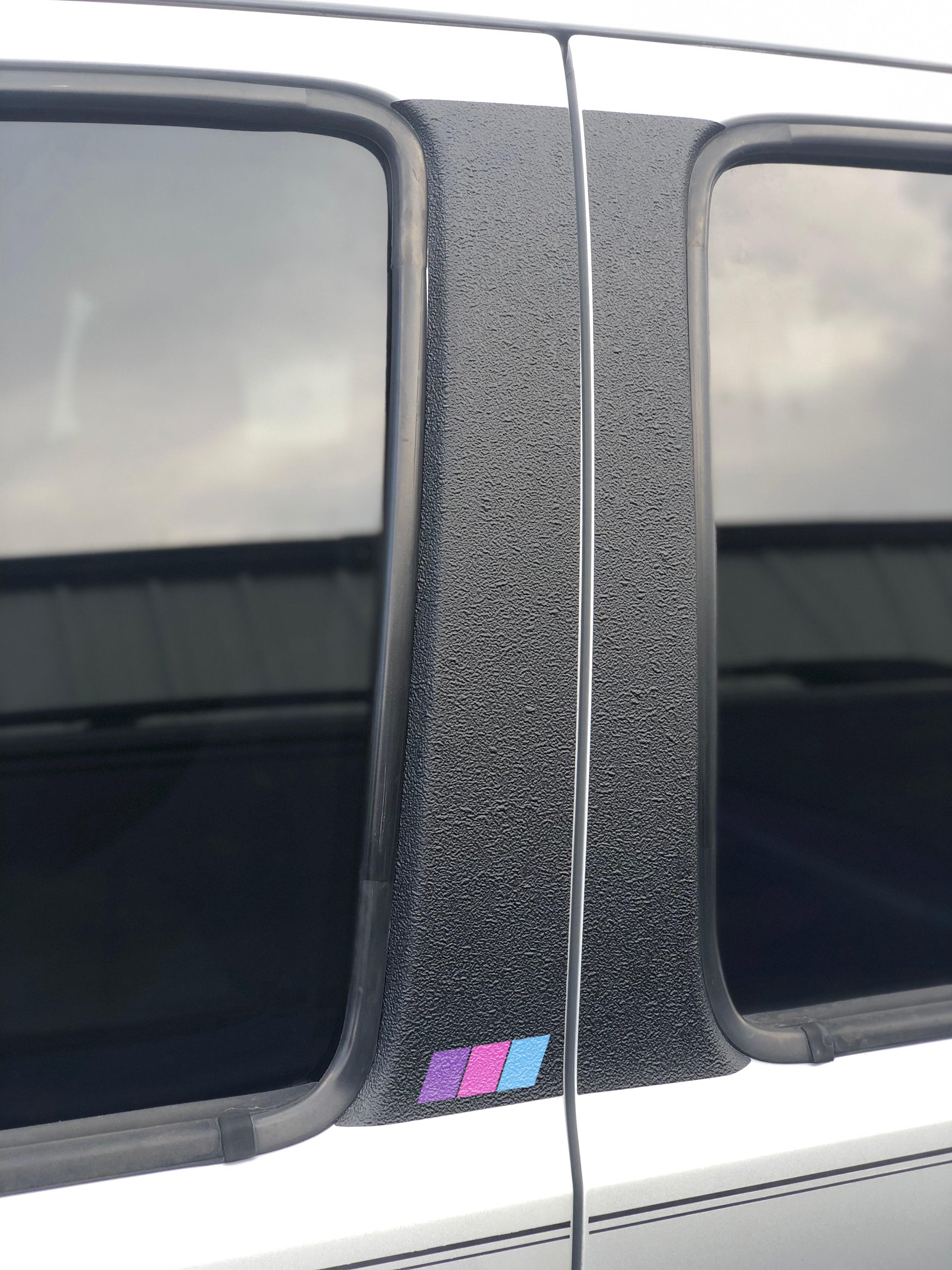 Textured door pillar protection overlay with tri-color accents in blue, purple, and pink, compatible with 2005-2015 Toyota Tacoma.