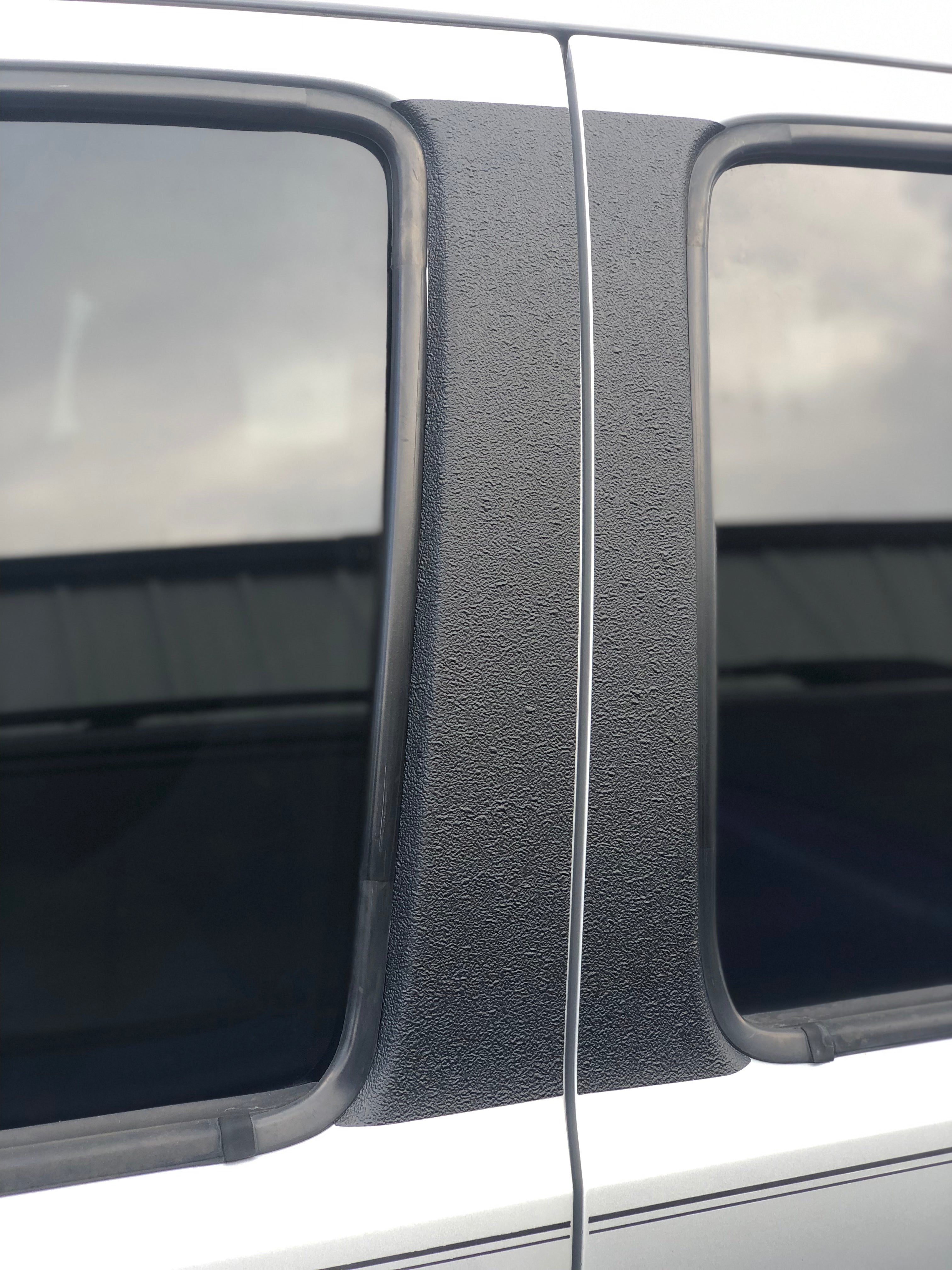 Textured door pillar protection overlay in solid black, designed for 2005-2015 Toyota Tacoma.