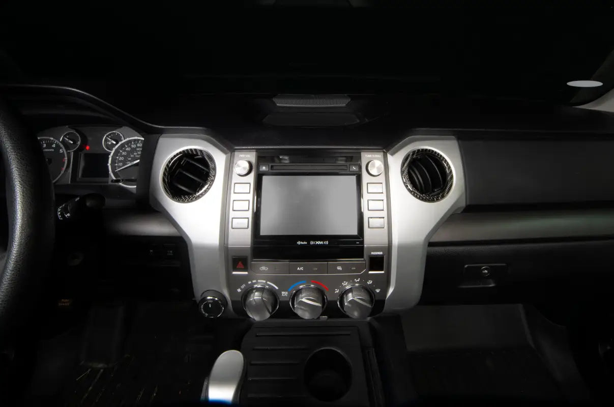 Close-up view of chrome A/C vent covers fitted on the dashboard of a 2014-2021 Toyota Tundra, showcasing sleek design.