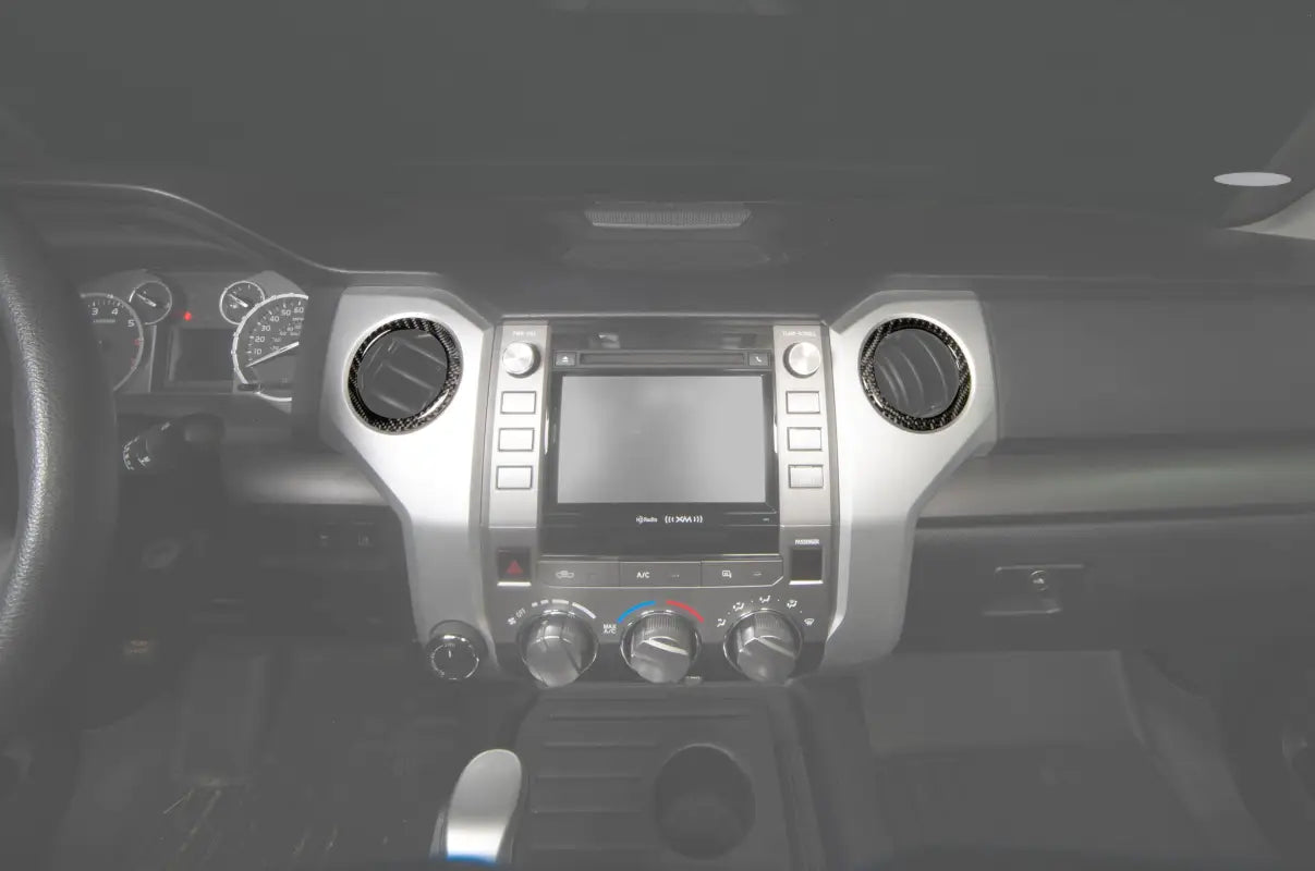 Chrome A/C vent rings installed on the dashboard of a 2014-2021 Toyota Tundra, enhancing interior aesthetics.