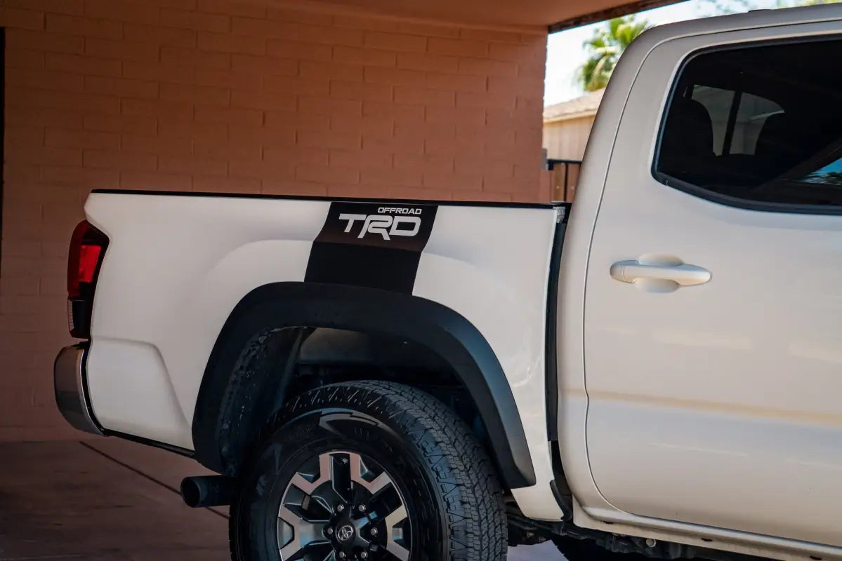 White Toyota Tacoma truck with Alpha Bed Decals showcasing stylish bed decals