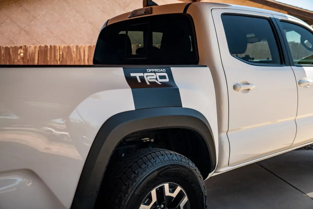 White Toyota Tacoma truck with Alpha Bed Decals for customized bed decals