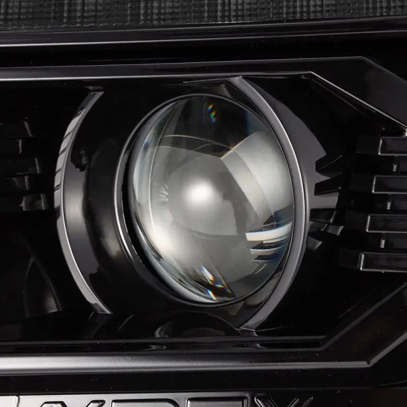 Close-up view of AlphaRex LUXX-Series LED projector lens showcasing precision optics for enhanced visibility and style.