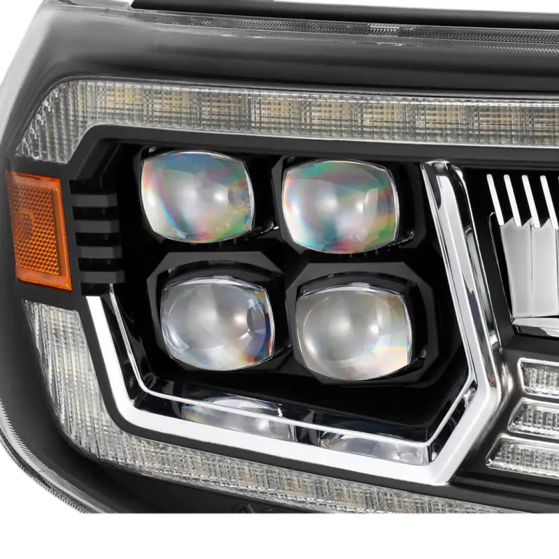 Close-up of AlphaRex NOVA-Series projector headlights showcasing quad LED projectors and modern design for Toyota Tacoma (2005-2011).